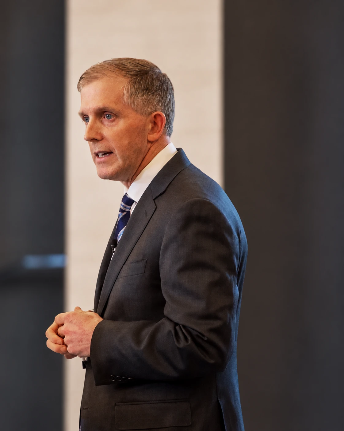 Jack Ryan speaking at a lectern, mid-gesture